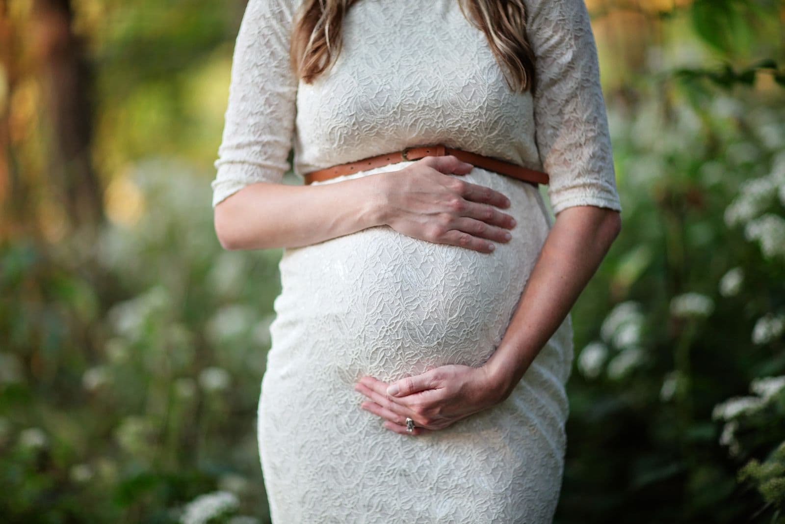 A pregnant woman cradling her belly